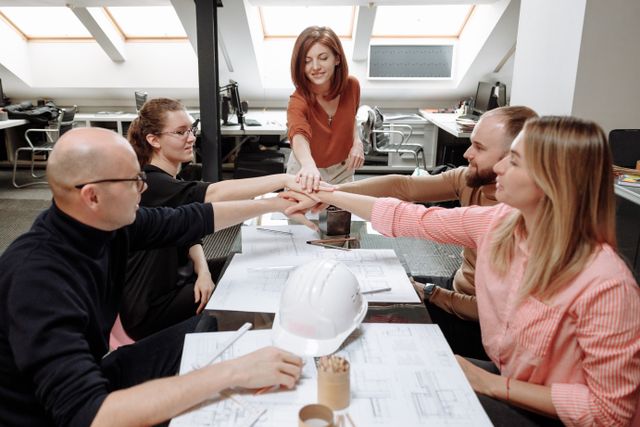 Architects collaborate on project plans in a modern office setting.